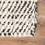Macro detail of Almand rug corner with chunky weave featuring black and white fibers