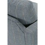 Close-up on angled top corner of armrest and back cushion stitching details