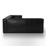 Rear view emphasizing smooth leather back panel and contrast stitching on black sectional