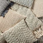 Close-up shot showing Kaz pillow combined with other textured pillows and beige throws