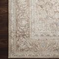 Close-up of the rug’s corner on wood flooring emphasizing subdued colors and intricate woven border