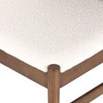 Detailed view of plush white faux shearling fabric on square seat cushion corner