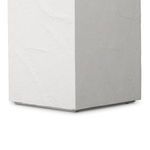 Close side view of the pedestal's bottom corner showing clean edges and texture