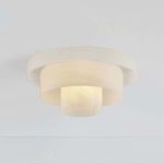 Flush mount ceiling light installed and lit, showing warm glow through cloud glass shades