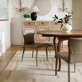 Max rug styled in dining room under wooden table with brown chairs and beige console