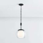 Pendant light with clear glass exterior and opal fluted interior orb, finished in aged brass