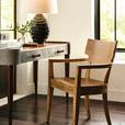 Juhl Arm Chair in natural wood styled next to desk with lamp in bright room with large windows