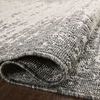 Folded section of the rug revealing the dense weave and backing material