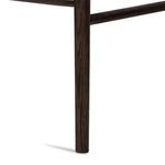Close-up of a single rounded carbon-finished oak stool leg with visible wood grain