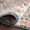 Edge close-up with the rug rolled, highlighting thickness and pile softness
