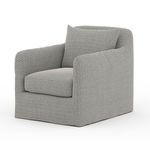 Dade Outdoor Swivel Chair angled left emphasizing soft, rounded armrests and textile detail