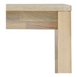 Close-up of timber joinery between table leg and apron under beige stone top