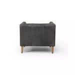Back view of ebony leather chair with visible vertical stitching and tapered wooden legs