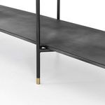 Close-up of metallic brass-capped leg detail on the bottom of the bookshelf frame