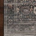 Side angle view of Lyra Ink rug showing low pile height and detailed border patterns