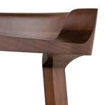 Close-up of curved hardwood backrest corner showing smooth grain and craftsmanship