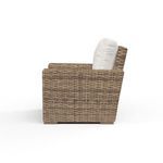Side profile view of Havana Club Chair showing thickness of all-weather wicker frame and beige cushions