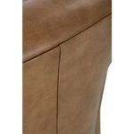 Side close-up of chair's armrest edge featuring clean seams and fine leather grain