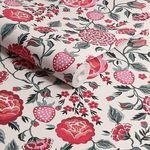 Close-up of rolled Strawberry Garden wallpaper displaying repeated strawberry and rose pattern