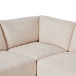 Close-up corner detail of Toland sectional featuring cushioned back and seat in cream fabric