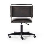 Wharton chair rear view focusing on padded backrest and slim iron frame
