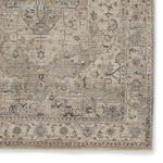 Zoomed-in section highlighting intricate floral and geometric patterns within the border of the rug