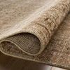 Folded section of Heritage Clay / Natural rug showing texture and weave on hardwood floor