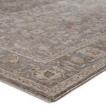 Angled close-up of rug corner border highlighting woven pile and subtle shading