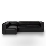 Front view emphasizing sleek cushions and low backrest of black sectional