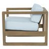 Side profile highlighting chair’s frame design and cushion thickness with open teak arm structure