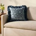 Kathleen Blue Pillow styled on beige corduroy sofa with decorative flowers on side table