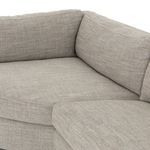 Close-up angled view of cushions and armrest corner showing fabric texture and structure