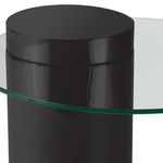 Close-up of top section of black cylinder base beneath clear glass surface