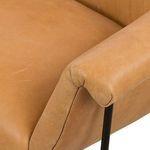 Close-up of curved armrest leather texture and stitching
