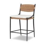 Three-quarter view showing curved metal frame and raised metal footrest of stool