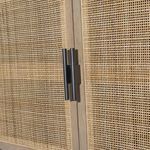 Back panels of sideboard with matte black finish and centered cord cutouts