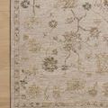 Close-up on Willa Bone / Multi rug corner on wood floor showing detailed floral patterns and border