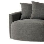 Close-up focusing on seat cushion fabric with tight weave and two pillows