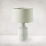 Lamp with power cord and hand-painted checked base on neutral background, shown from slightly elevated angle.