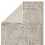 Back corner of rug folded over exposing light cream reverse