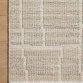 Top-down view of Asha Dove Rug on wooden floor highlighting raised textured pattern detail