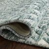 Close-up of rug rolled up showing plush texture and dense weave on underside