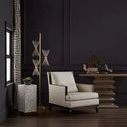 Console table in a dark modern room setting beside a cream armchair and decor accents