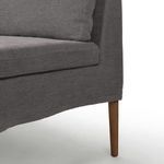 Close-up of curved left armrest and seat cushion seam on banquette's Broadway Denim upholstery
