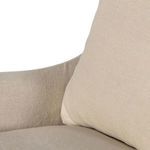 Close view on loose back cushion and armrest showing cotton linen fiber texture