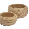 Set of two round natural bamboo baskets with woven holes and warm earthy tones