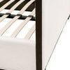 Close-up of bed base showing wooden slats and black metal frame supports