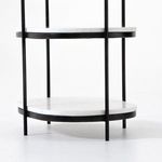 Slim black iron frame supporting three stacked oval white marble shelves on Felix Oval Nightstand