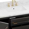 close-up of white marble countertop with gold faucet and rectangular undermount sink