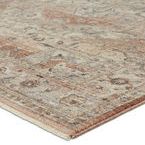 Close-up angle showing subtle dimensional sheen and woven texture of tan and pink rug medallion corner